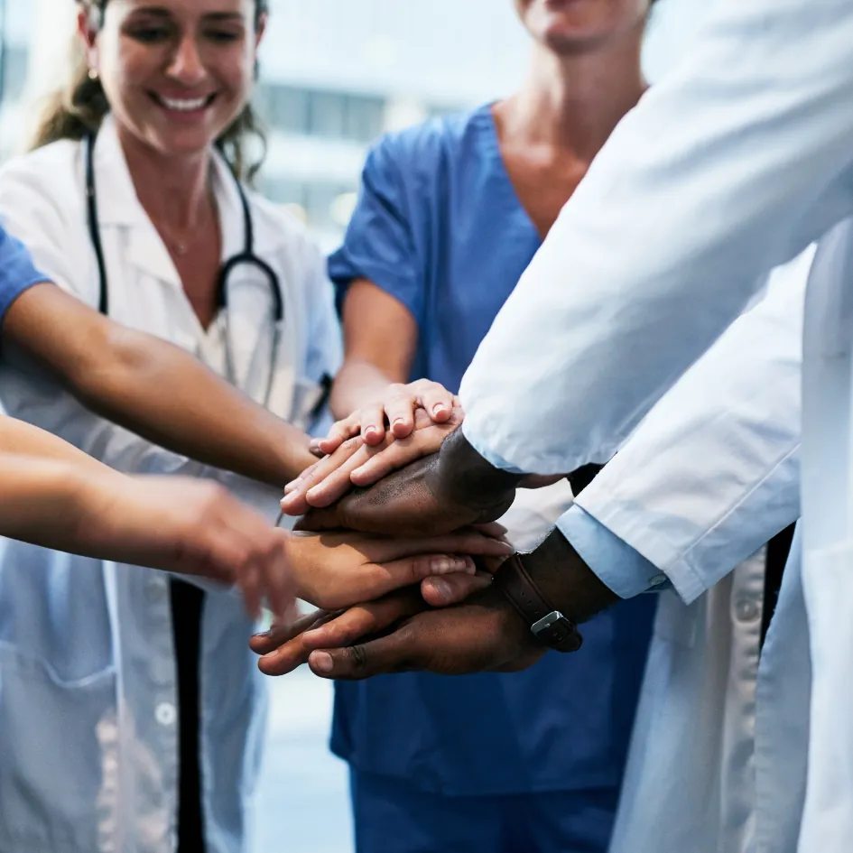 Medical team stacking hands