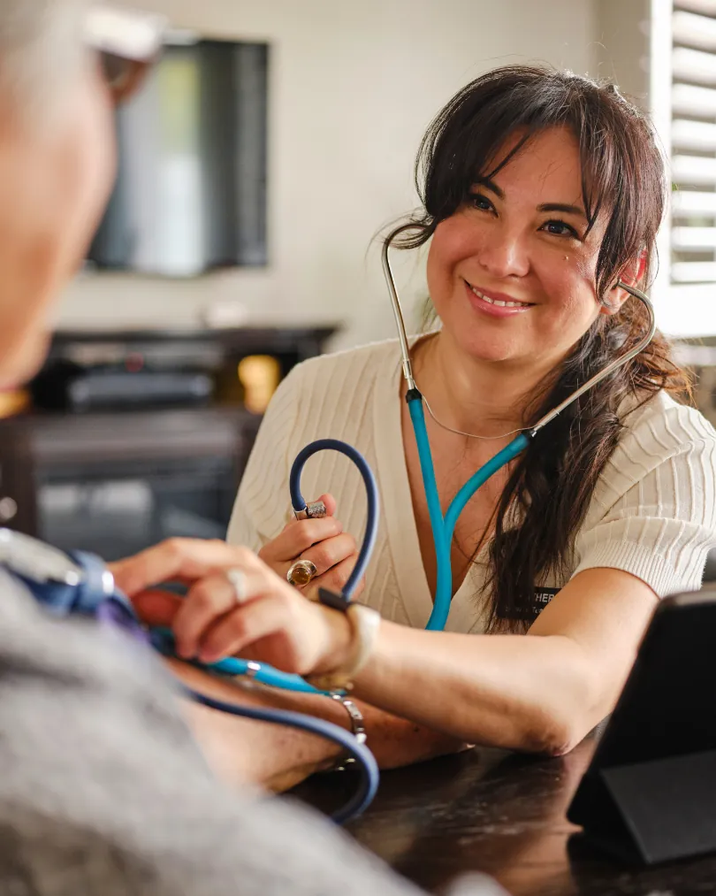 Provider taking a patient's blood pressure
